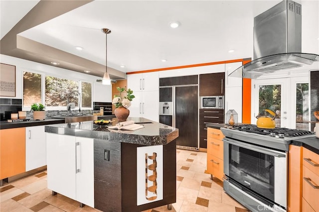 kitchen with stainless steel gas range oven, a center island, sink, white cabinetry, and island exhaust hood