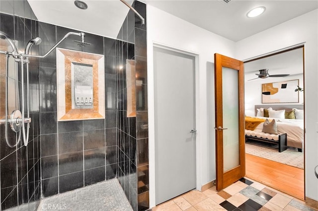 bathroom featuring ceiling fan and a tile shower