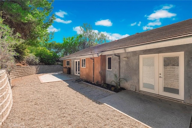 view of home's exterior featuring a patio and french doors