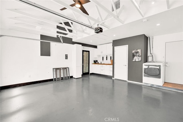 garage featuring ceiling fan, washer / dryer, and a garage door opener