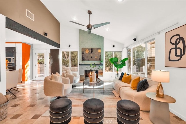 living room featuring a large fireplace, high vaulted ceiling, and ceiling fan