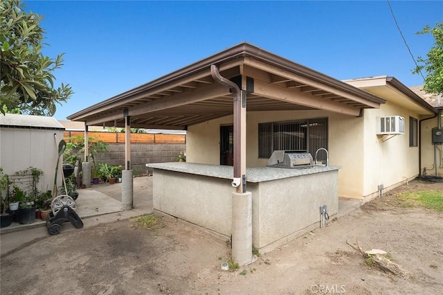 view of patio featuring a wall mounted air conditioner