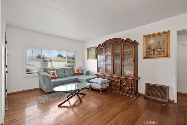 living room featuring hardwood / wood-style floors and heating unit