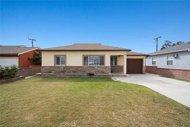 view of front of property with a garage and a front lawn