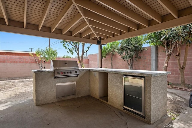 view of patio featuring area for grilling, sink, and grilling area