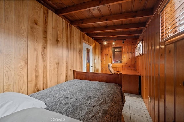 bedroom with beamed ceiling, wood walls, wood ceiling, and light tile patterned floors