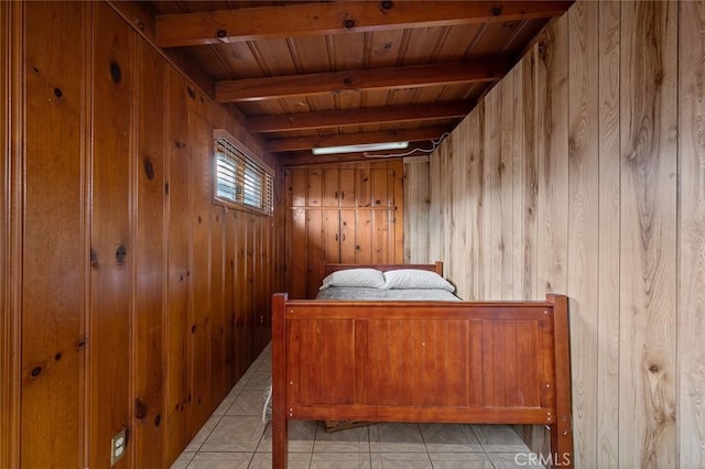 bedroom featuring beamed ceiling, light tile patterned floors, wooden walls, and wooden ceiling