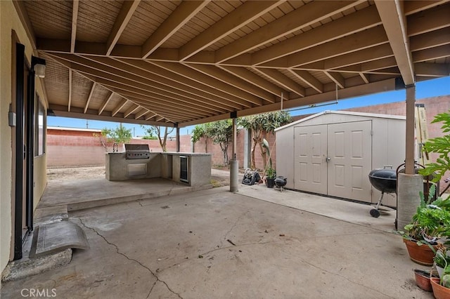 view of patio with a grill and a storage shed