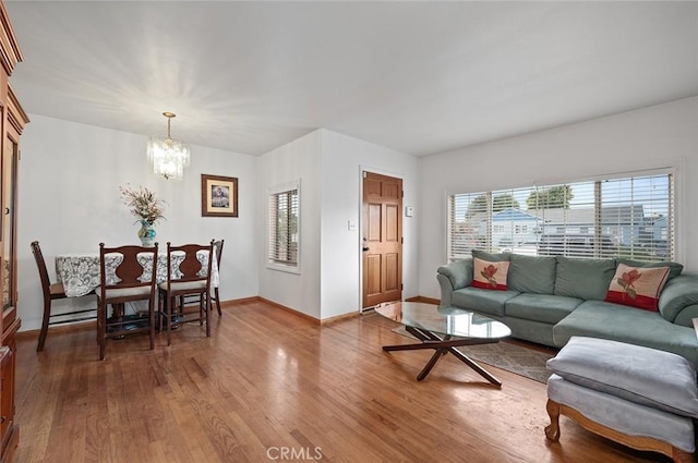 living room with a chandelier and hardwood / wood-style flooring