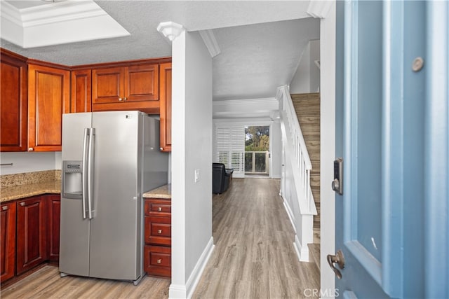 kitchen featuring light stone countertops, a textured ceiling, stainless steel fridge with ice dispenser, crown molding, and light hardwood / wood-style flooring