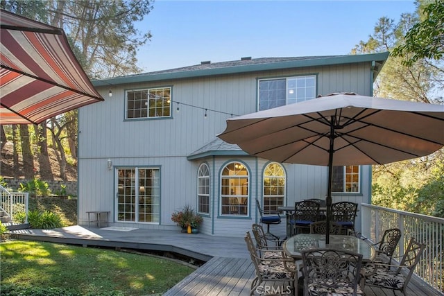 back of property featuring a wooden deck