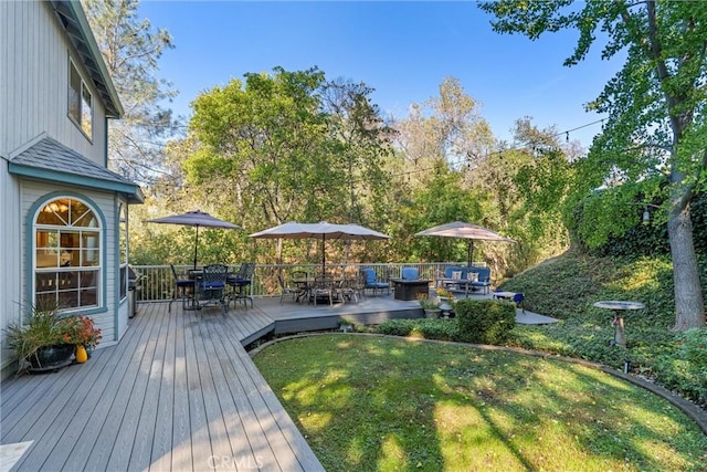 wooden terrace with a yard