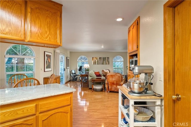 kitchen featuring light hardwood / wood-style floors and light stone counters