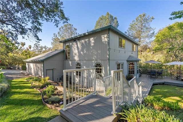 back of property featuring a lawn, a deck, and central AC