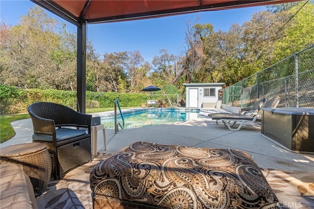 view of pool featuring an outbuilding, outdoor lounge area, and a patio area