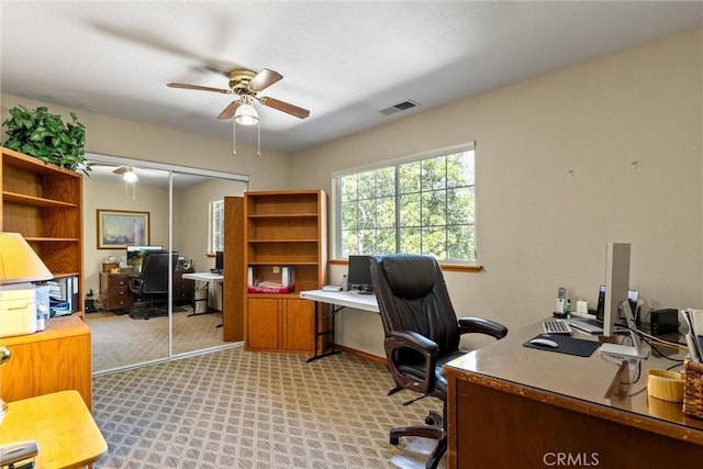 office with ceiling fan and light carpet