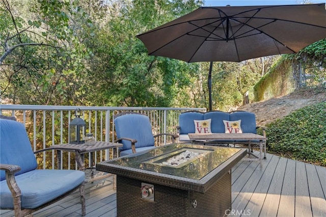 wooden deck featuring an outdoor fire pit