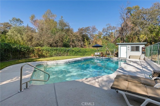 view of pool featuring a patio area and an outdoor structure