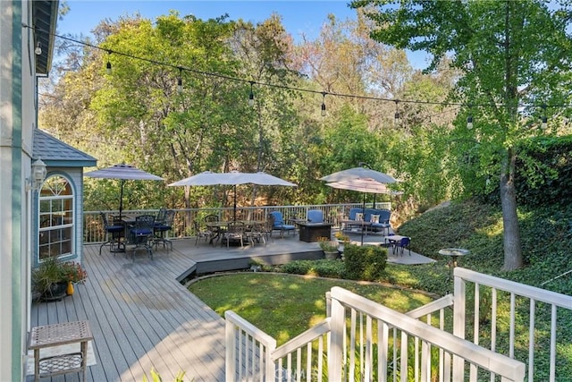 wooden deck with a lawn