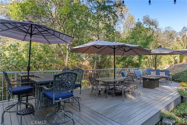 wooden terrace with a fire pit