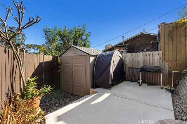 view of patio / terrace featuring a storage shed