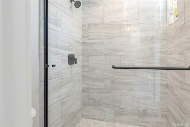 bathroom with a shower with door