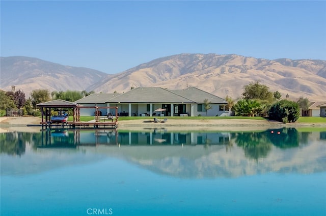 view of swimming pool featuring a water and mountain view and a lawn