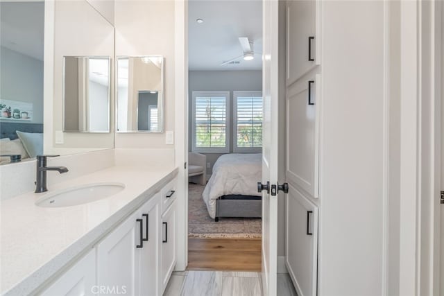 bathroom with vanity, hardwood / wood-style floors, and ceiling fan