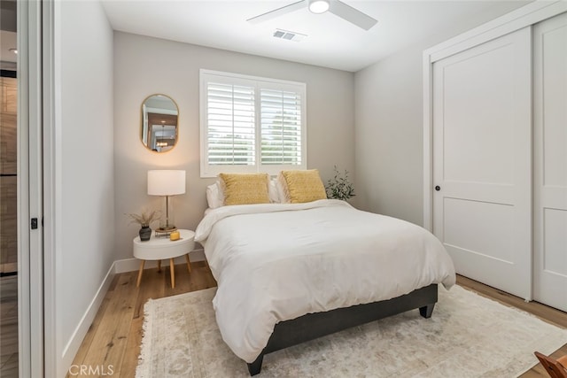 bedroom with light hardwood / wood-style floors, a closet, and ceiling fan