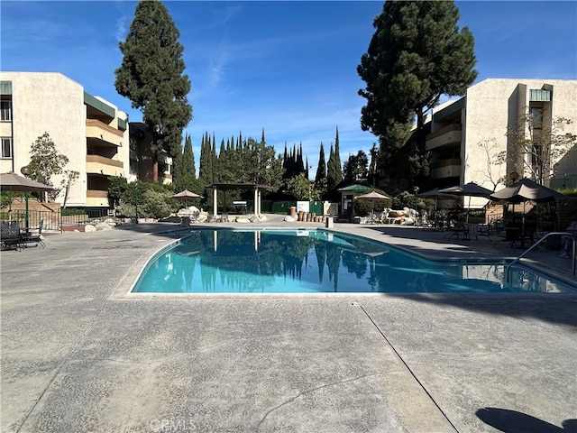 view of swimming pool with a patio area