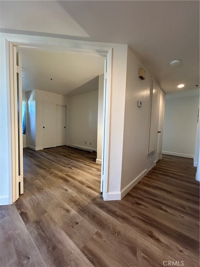 corridor featuring dark hardwood / wood-style flooring