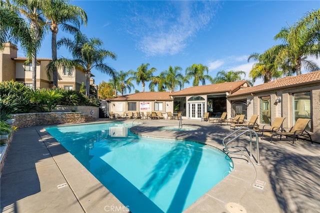 view of pool featuring french doors and a patio