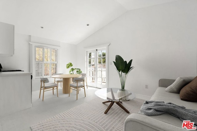 living room with light carpet, french doors, and high vaulted ceiling