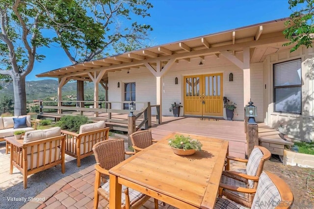 view of patio / terrace featuring a wooden deck, outdoor lounge area, and french doors