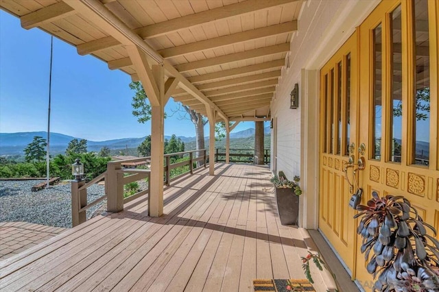 wooden deck featuring a mountain view