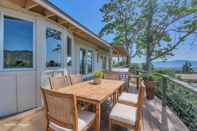 wooden deck with a mountain view and french doors