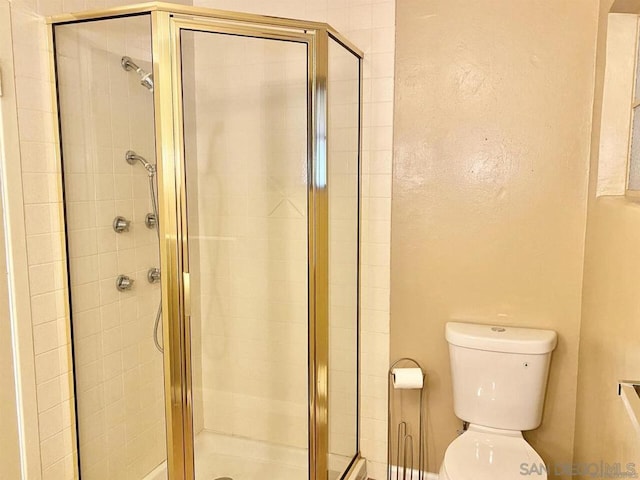 bathroom with toilet and walk in shower