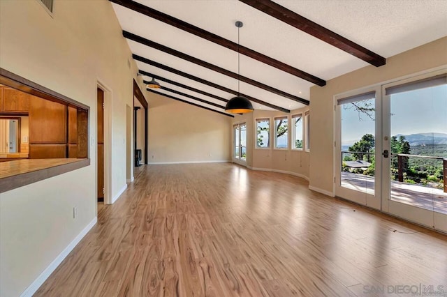 unfurnished living room featuring french doors, a textured ceiling, high vaulted ceiling, light hardwood / wood-style floors, and beamed ceiling