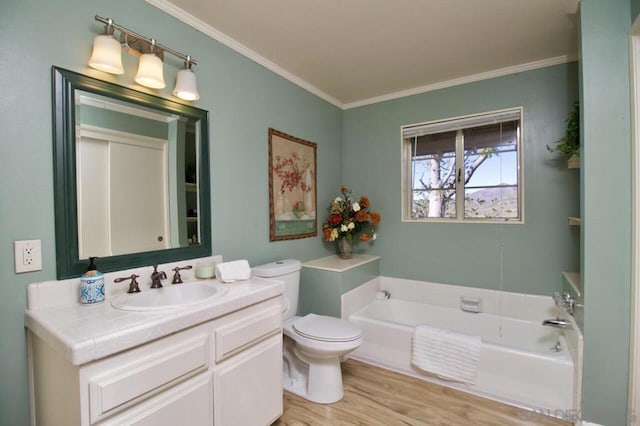 bathroom featuring toilet, hardwood / wood-style flooring, a tub to relax in, ornamental molding, and vanity