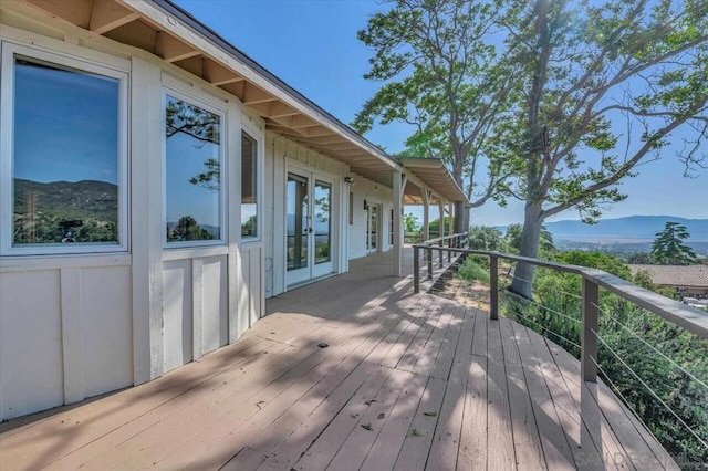 wooden terrace with a mountain view and french doors