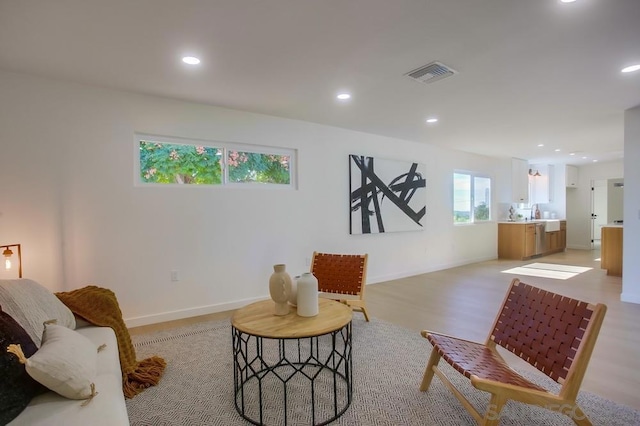 sitting room with light hardwood / wood-style floors and a wealth of natural light