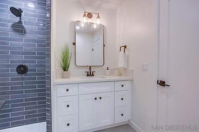 bathroom featuring vanity and tiled shower