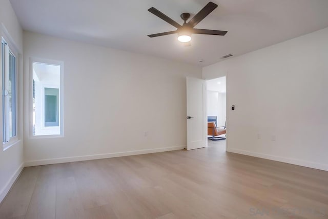 spare room featuring ceiling fan and light wood-type flooring