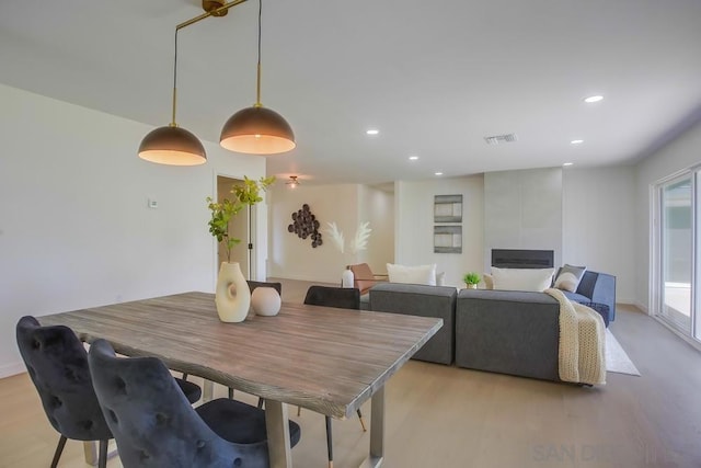 dining space with light wood-type flooring