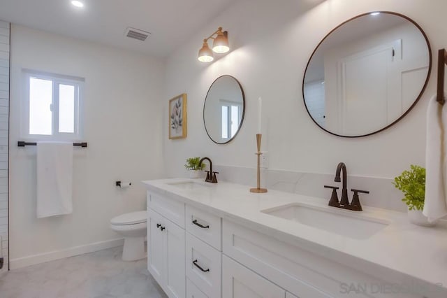 bathroom featuring vanity and toilet