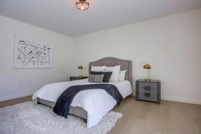 bedroom with hardwood / wood-style flooring