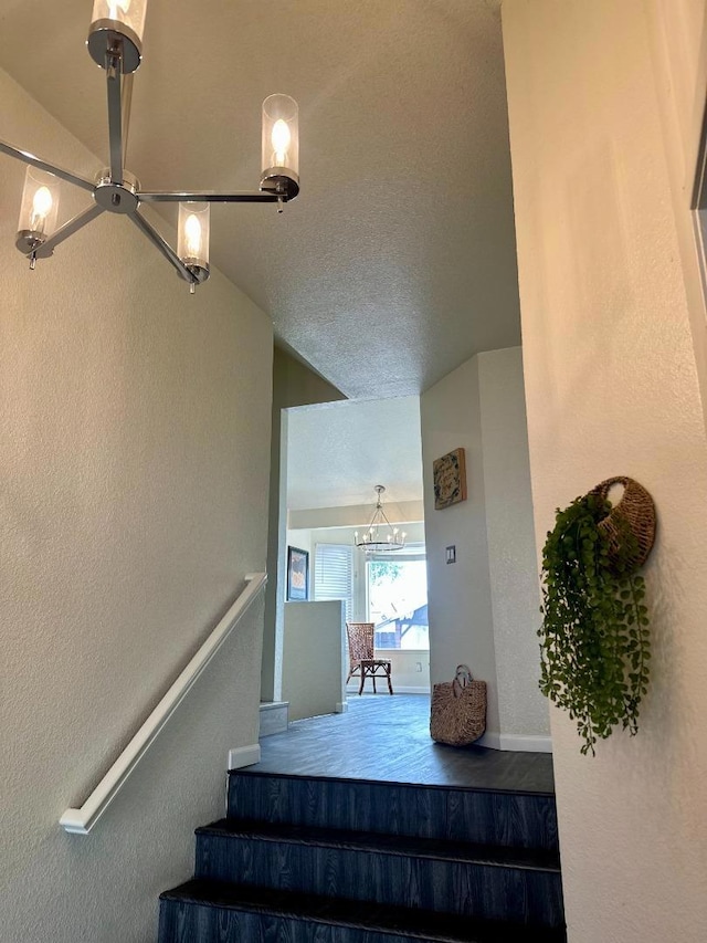 stairs with a chandelier