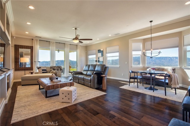 living room with a mountain view, a healthy amount of sunlight, and dark hardwood / wood-style flooring