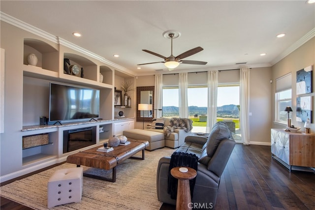 living room featuring crown molding, hardwood / wood-style floors, and ceiling fan