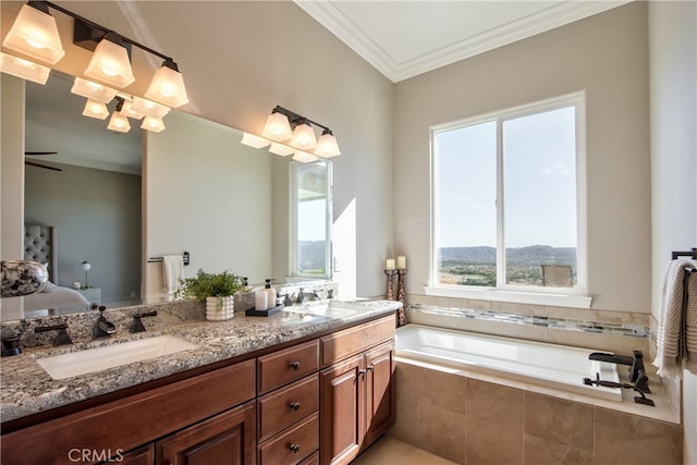 bathroom featuring vanity, ornamental molding, and tiled tub